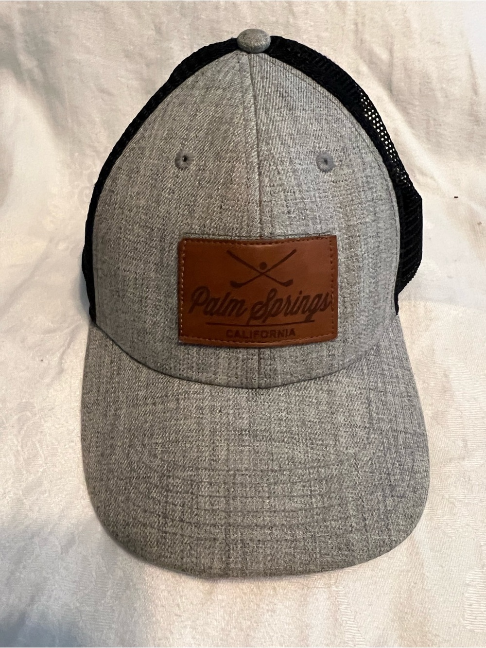 Legacy Palm Springs CA trucker hat with mesh sides and back and snap closure.